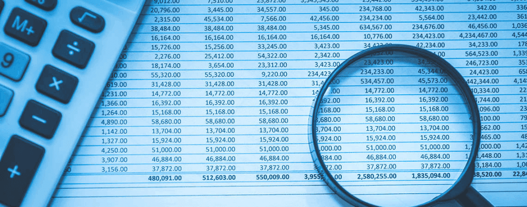 Printed account data sheet with a calculator and magnifying glass laying on top.